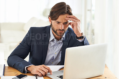 Buy stock photo A handsome businessman  focused on his work