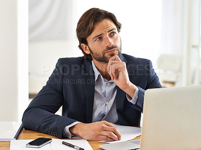 Buy stock photo A handsome businessman reflecting over his thoughts while at his desk