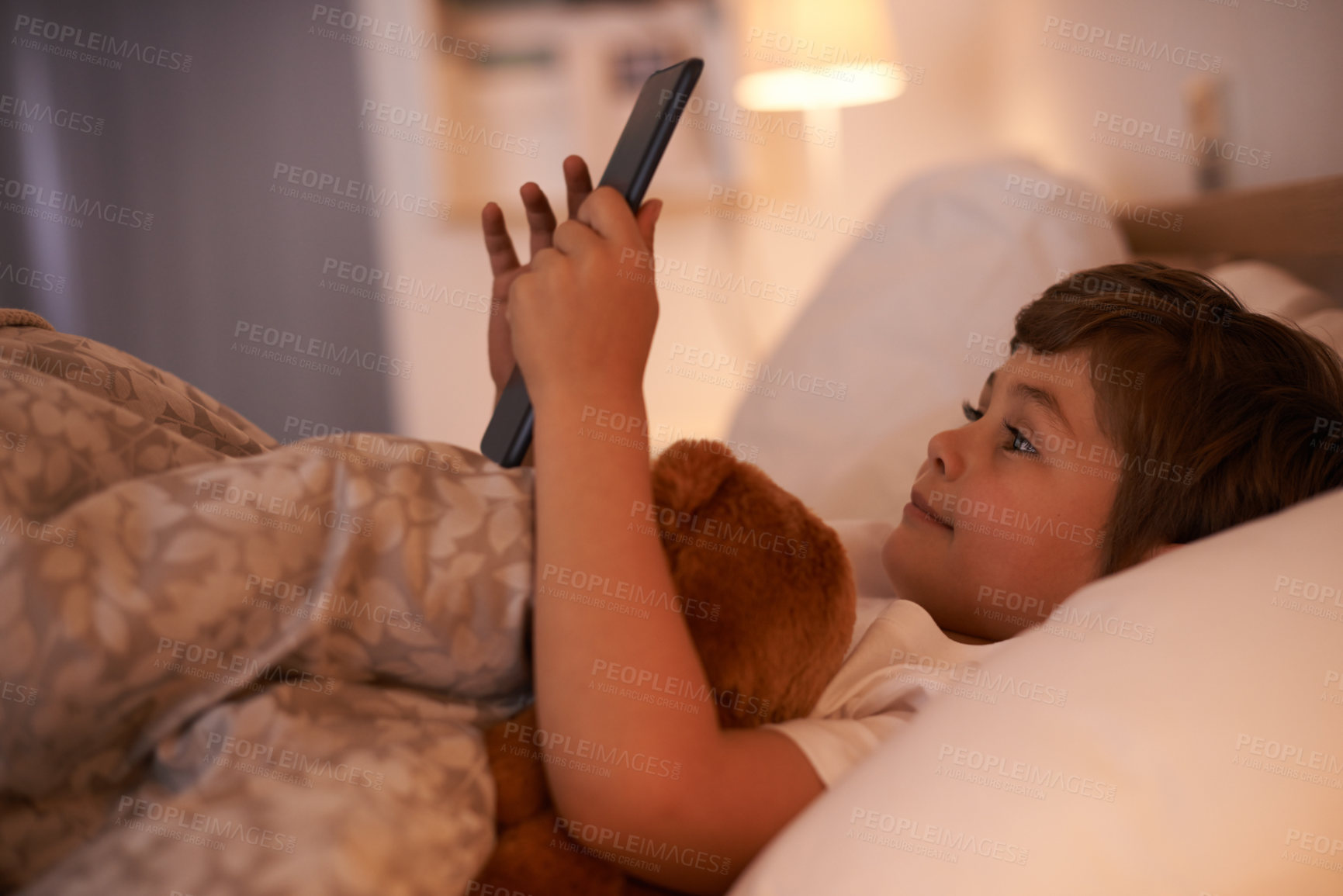Buy stock photo Boy, child and tablet in bedroom at night for typing, reading or online game with app in family home. Kid, bed and digital touchscreen for movie, cartoon and streaming subscription to relax in house