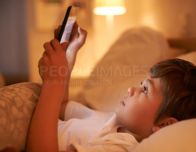 Buy stock photo Boy, kid and tablet in bedroom at night for typing, reading or online game with app in family home. Child, bed and digital touchscreen for movie, cartoon and streaming subscription to relax in house