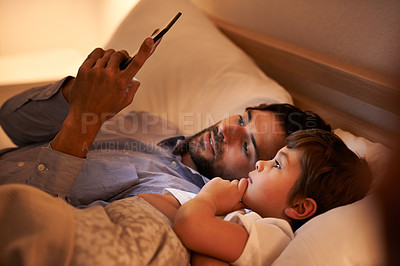 Buy stock photo Home, father and son with tablet, night and family with storytelling and connection with social media. Dad, house and boy with technology and bedtime story with lights and bonding together with app