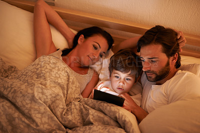 Buy stock photo Family, together and movie on tablet in bed, digital and educational for learning of child. Parents, love and technology with connection to internet for bonding, mom and dad relax with son in bedroom