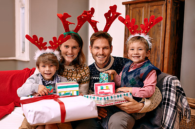 Buy stock photo Portrait, smile and family with present for Christmas, holiday or together at festive celebration on sofa at home. Xmas, parents and happy children with gift in living room, face or antlers at party