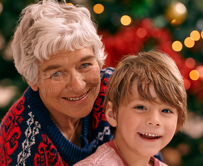 Buy stock photo Christmas, portrait and celebration in living room, grandma and grandchild smile with happiness. House, elderly woman and kid together for holiday as family in lounge, tree and love   in home