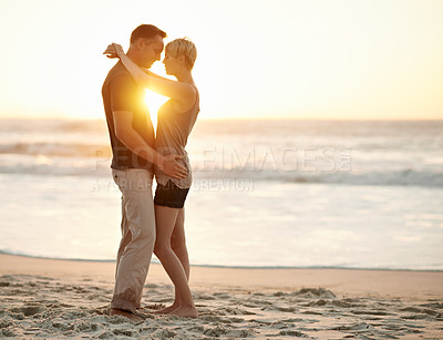 Buy stock photo Couple, embrace and romance in sea at sunset to relax, vacation and happy in trip. Partners, together and water in beach to enjoy, calm and smile for love of marriage in  honeymoon and holiday