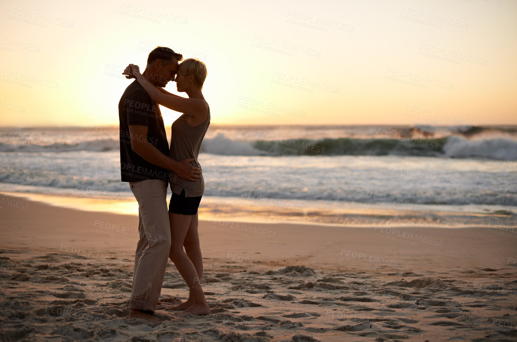 Buy stock photo Couple, together and romance at sunset in ocean for peace in trip and vacation. Partners, embrace and relax in sea with water to enjoy, calm and smile for love of marriage in  honeymoon and holiday