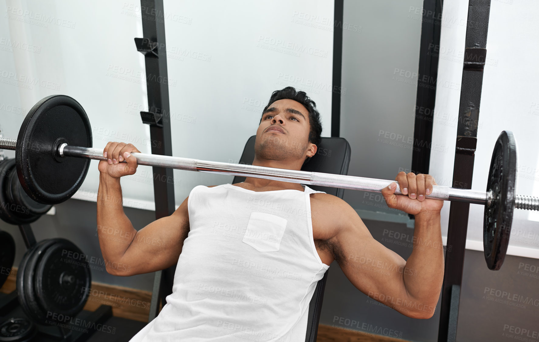 Buy stock photo Bench, press and man at gym for exercise, workout and body building in Mexico. Healthy, person and weightlifting challenge for strong muscle, fitness or progress in training arms with barbell in club