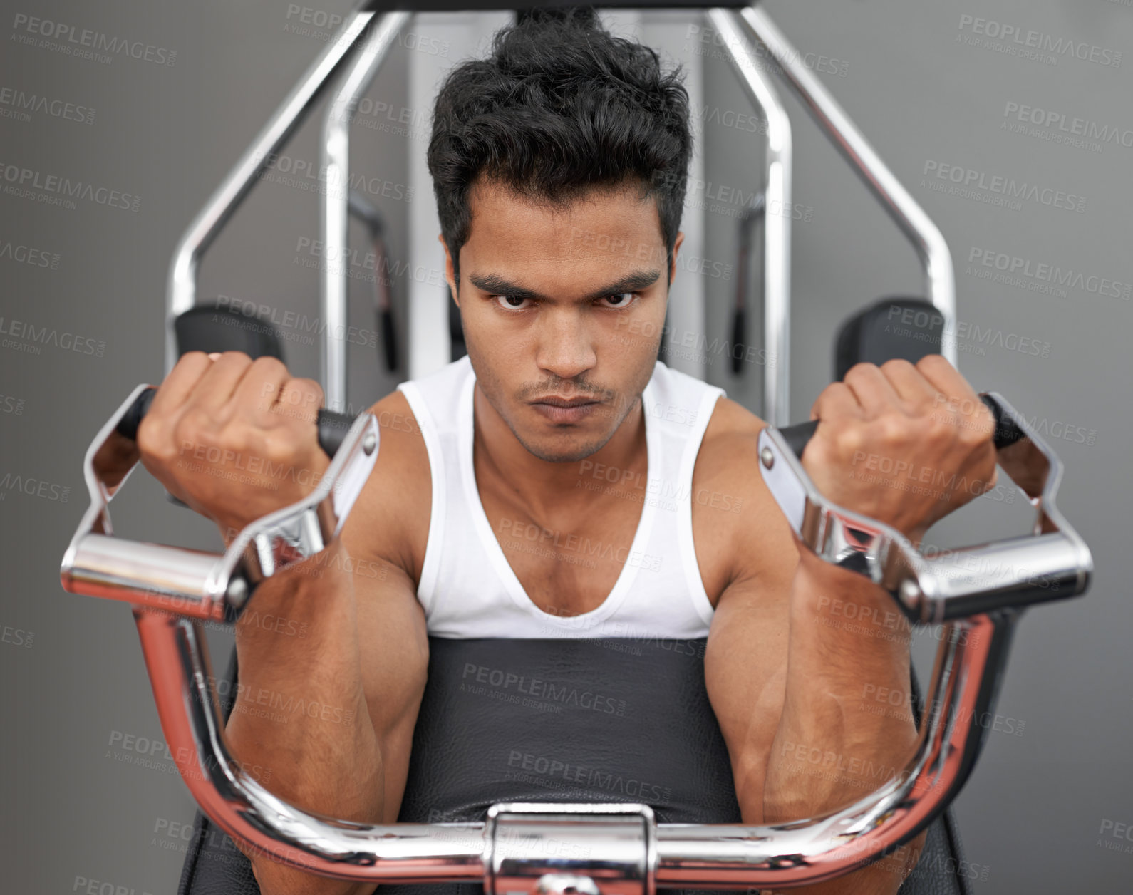 Buy stock photo Portrait, fitness and bicep machine with man in studio on gray background for serious workout. Face, exercise and equipment for strong muscles with confident young athlete training arms at gym