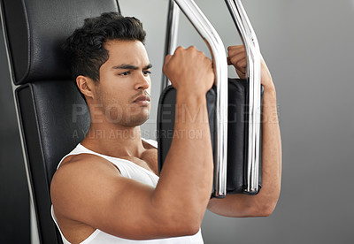 Buy stock photo Fitness, chest exercise machine and man in studio isolated on gray background for muscle workout. Exercise, health or wellness and serious young bodybuilder athlete training with equipment at gym