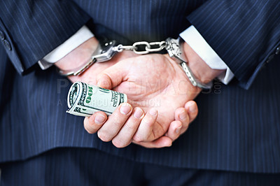 Buy stock photo Business person, hands and money with handcuffs for bribe, secret or corruption in financial crime. Closeup or rear view of employee with roll of cash, paper or laundering finance in bribery or fraud