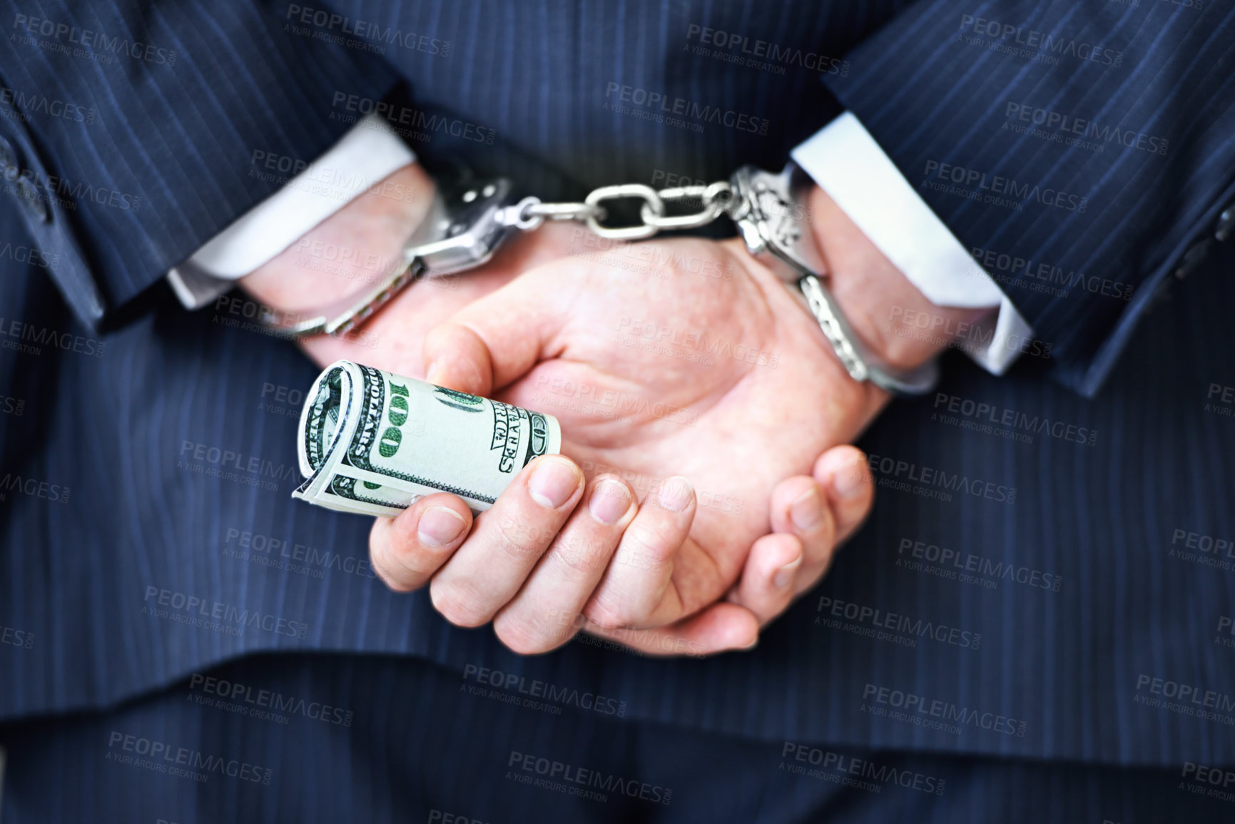 Buy stock photo Business person, hands and money with handcuffs for bribe, secret or corruption in financial crime. Closeup or rear view of employee with roll of cash, paper or laundering finance in bribery or fraud
