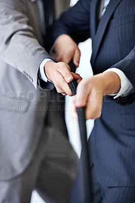 Buy stock photo Hands, effort and tug of war with businessmen in studio for collaboration or competition. Teamwork, partnership and challenge with corporate people pulling rope together for strength or struggle