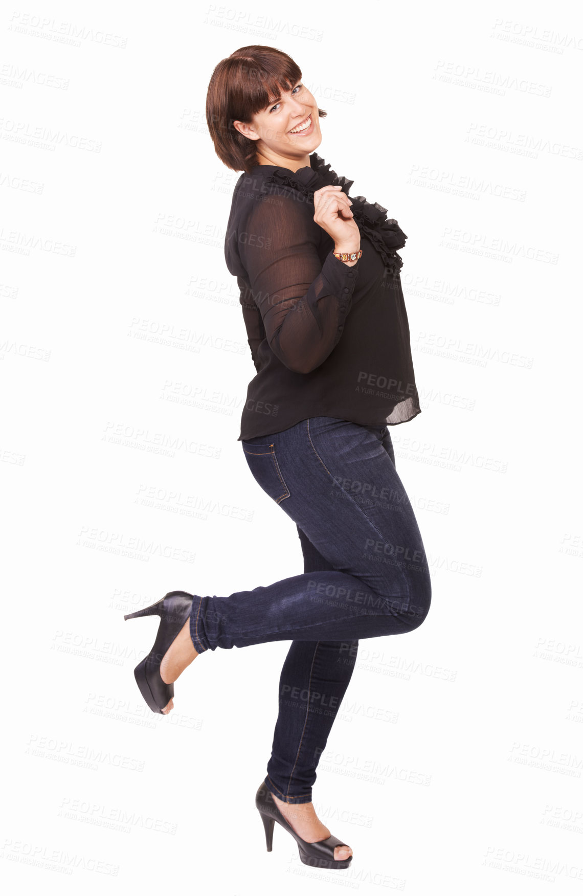 Buy stock photo Portrait of a playful young brunette woman lifting on foot on a white background