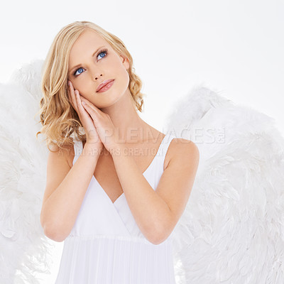 Buy stock photo Woman, face and beauty in studio with angel wings for halloween dress up, celestial fashion and confidence. Model, person and thinking with heavenly costume and natural makeup on white background