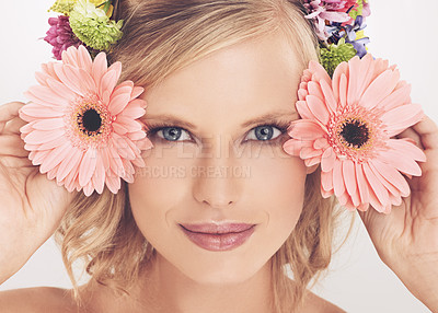 Buy stock photo A young woman with a flower arrangement in her hair smiling at the camera