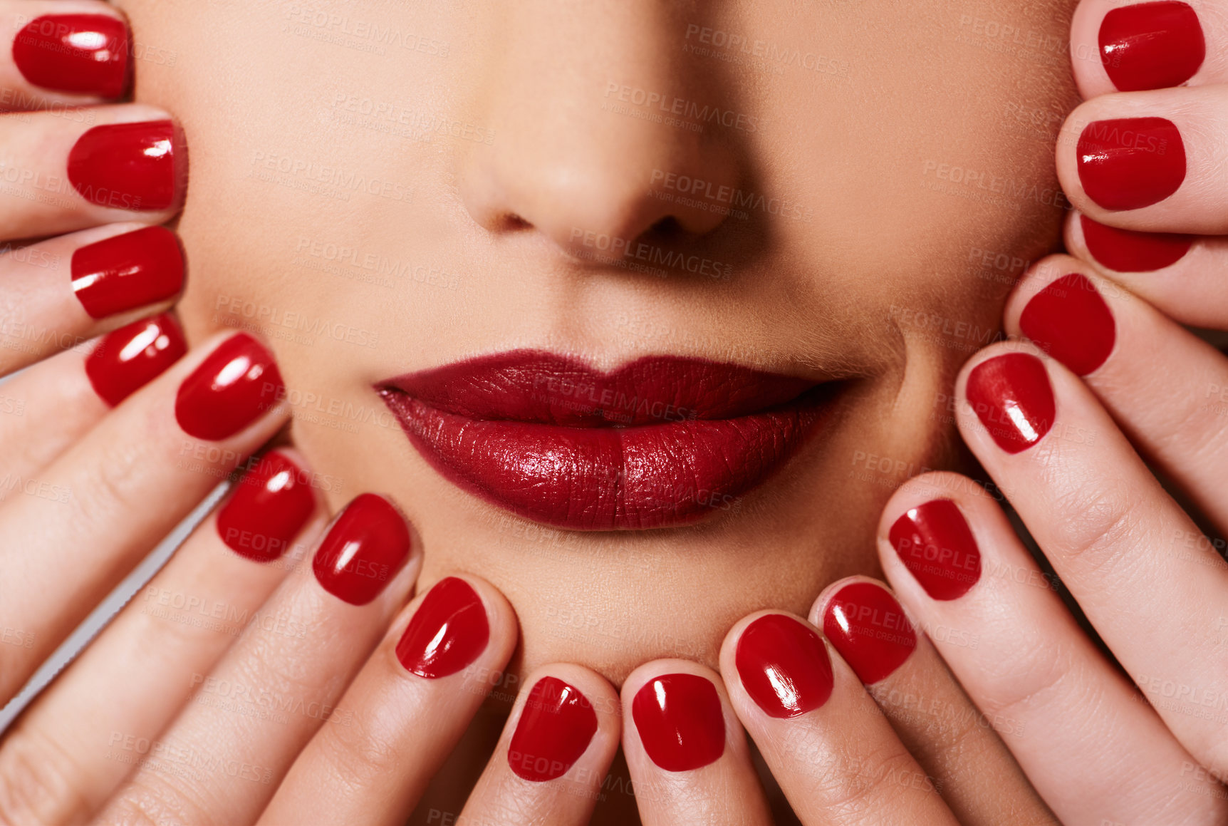 Buy stock photo Beauty, cosmetics and woman with manicure, red lipstick and creative aesthetic for glamour. Luxury makeup, face and hands with nail polish for self care, shine and happy mouth of model with product