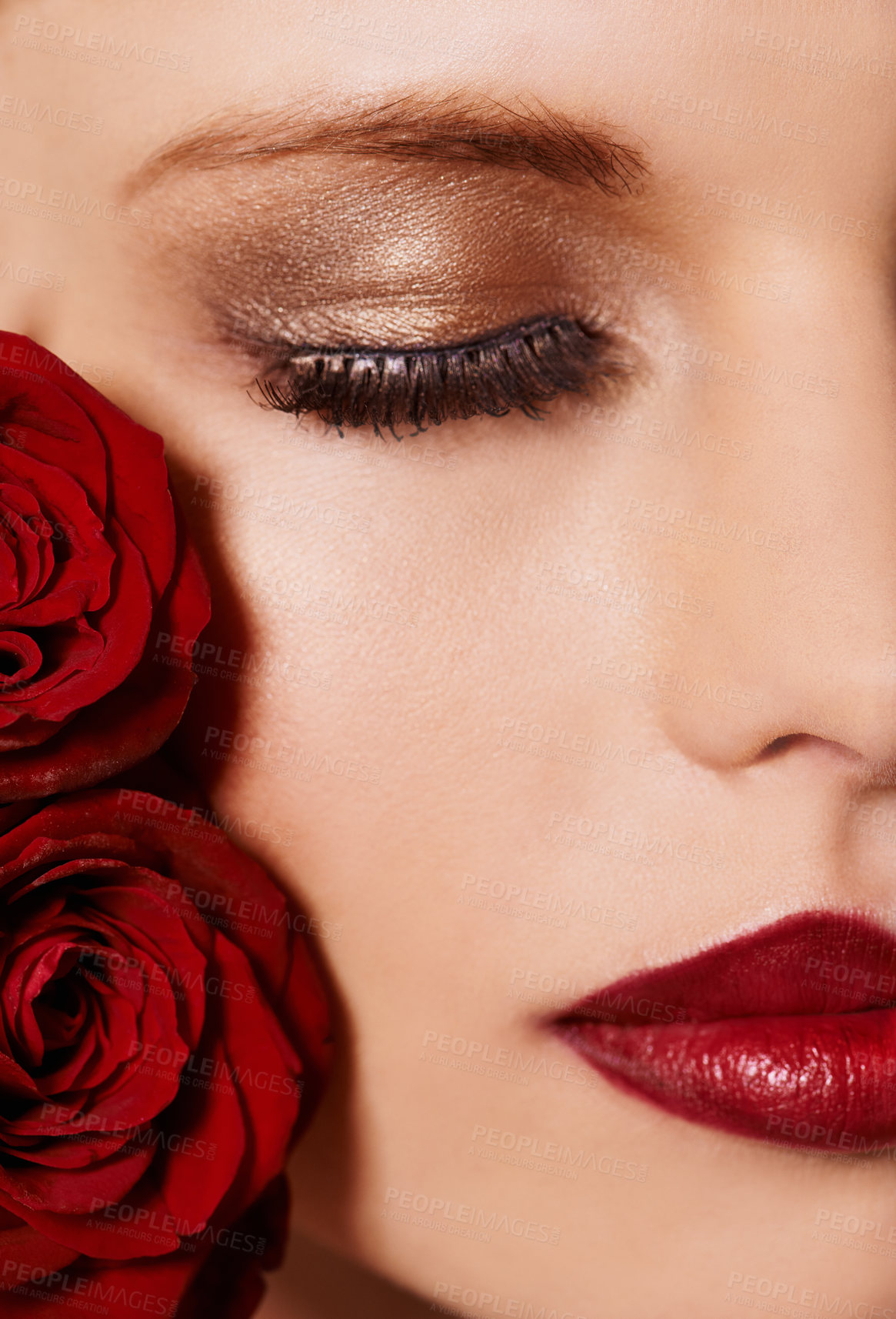 Buy stock photo Closeup of face, makeup and beauty with roses, red lipstick and gold eyeshadow with lashes for cosmetics. Shimmer, shine and bold aesthetic, romantic flowers and cropped  with skin and cosmetology