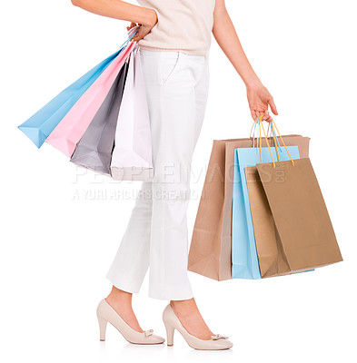 Buy stock photo Fashion, shopping and legs of woman on a white background with bags for sale, discount and deal. Shopper, customer and closeup of isolated person for retail, consumerism and purchase in studio