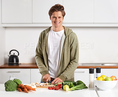 Buy stock photo Portrait of a young man preparing dinner