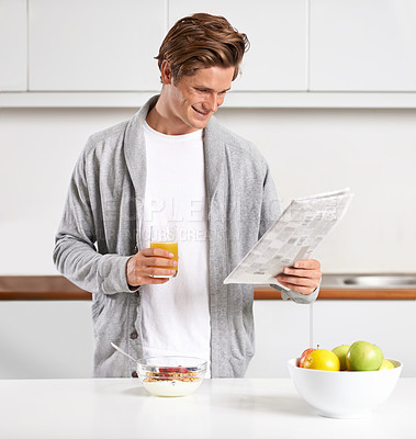 Buy stock photo Breakfast, juice and man with newspaper in kitchen for information at modern apartment. Nutrition, cereal and young male person drinking healthy beverage and reading public journalism at home.