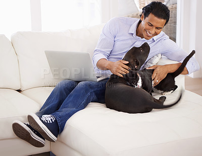 Buy stock photo Man, dog and happiness with laptop on sofa for bonding, playing and face with remote work in home. Animal, person and comfort with smile on couch in living room for research, cuddle or love for puppy