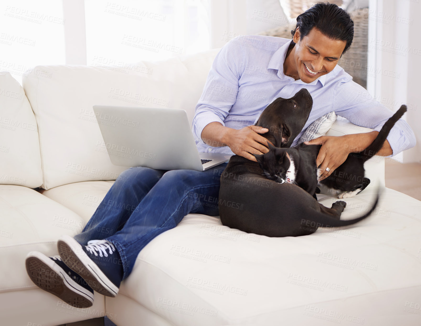 Buy stock photo Man, dog and happiness with laptop on sofa for bonding, playing and face with remote work in home. Animal, person and comfort with smile on couch in living room for research, cuddle or love for puppy