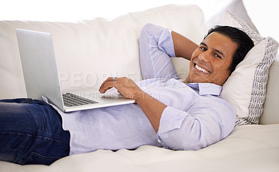 Buy stock photo Happy man, portrait and laptop and relax on sofa for remote work, email or communication at home. Handsome businessman or freelancer with smile on computer and lying on couch in living room at house