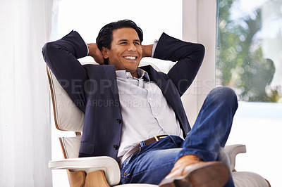 Buy stock photo Relax, stretching and businessman on a chair with relieved, smile or excited about work success in his home. Happy, chilling and male entrepreneur in a living room with chill, moment or stress relief