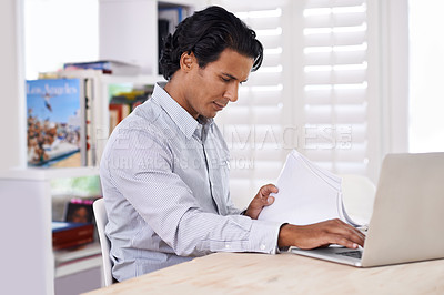 Buy stock photo Businessman, laptop and paperwork at desk in home for remote work, research or online planning in workspace. Financial analyst, person or technology with sales project, stock performance or documents
