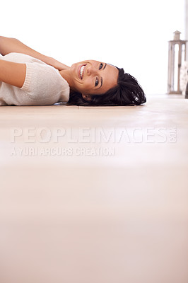 Buy stock photo Woman, portrait and smile on floor for relax with mock up space, weekend break and confidence in apartment. Person, lying down and face with happiness in home on wooden flooring for fun and ground