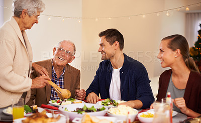 Buy stock photo Christmas, big family and eating lunch in home, smile and bonding together at party. Xmas, food and senior parents at table for festive celebration, relax and people on holiday with salad for meal