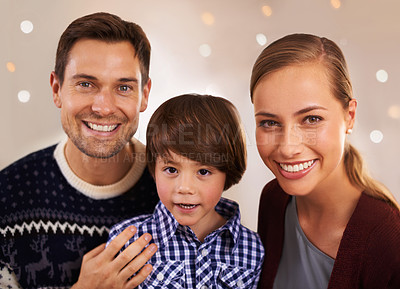 Buy stock photo Christmas, family and happy kid with parents in home for love, connection and bonding at festive celebration with bokeh. Xmas, face and child with mother, father and together at party on holiday