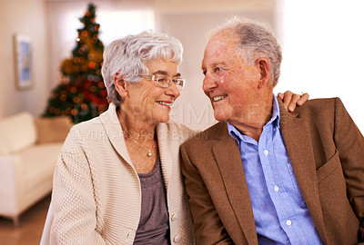 Buy stock photo Christmas, hug and old couple with love, smile and romance with marriage and festive season. Home, Xmas tree and embrace with elderly woman, senior man and relationship with retirement or celebration