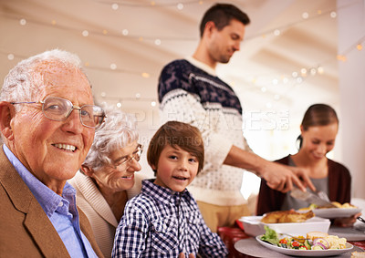 Buy stock photo Grandparents, portrait and family at dinner on Christmas, together with food and celebration in home. Happy, event and kid smile with old man at lunch and relax on holiday at table with grandmother