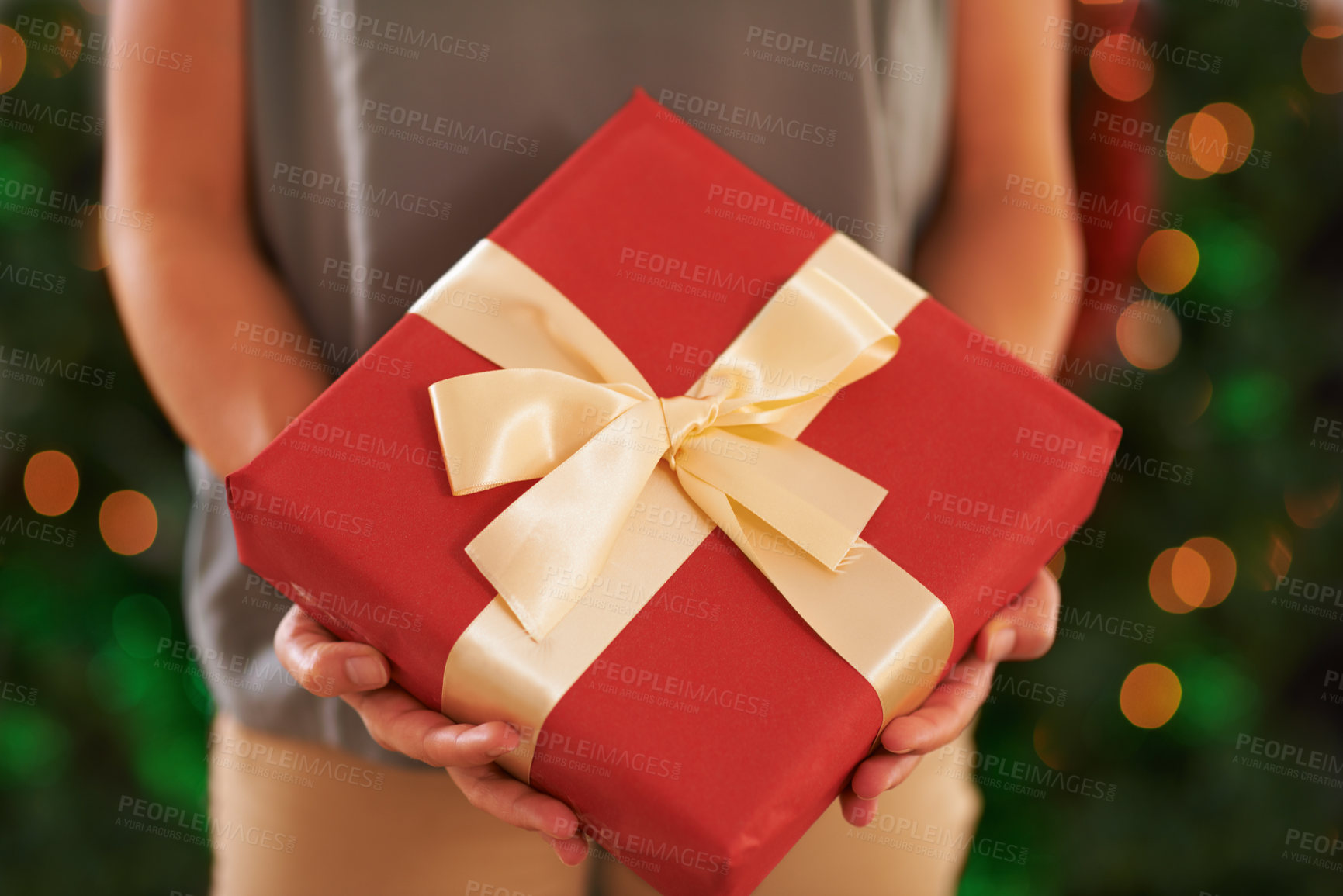 Buy stock photo Person, gift and Christmas box for festive season on holiday or present package for celebrate, party or decoration. Hands, fingers and giving in Canada with ribbon or joyful vacation, bokeh or lights