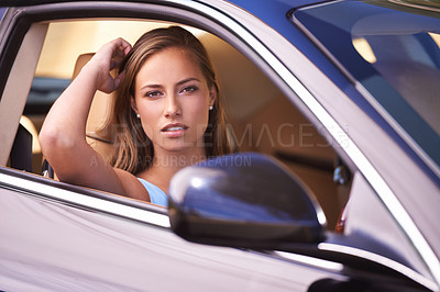 Buy stock photo An attractive young woman out for a drive in her sportscar