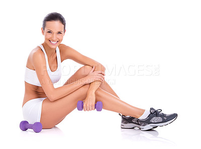 Buy stock photo Studio portrait of an woman in exercise clothing sitting on the floor with dumbbells isolated on white