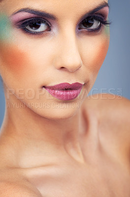 Buy stock photo Creative, makeup and portrait with woman in colorful cosmetics in studio and gray background. Beauty, cosmetics and model with unique identity or rainbow aesthetic with confidence in skincare