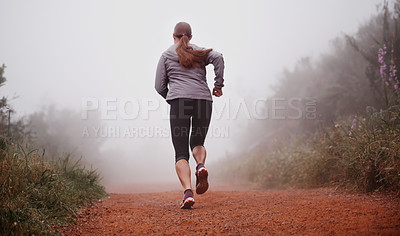 Buy stock photo Woman, rear view and running in woods with fitness for exercise, morning routine and workout with fog and legs. Athlete, person and cardio with sportswear on outdoor trail and forest for wellness