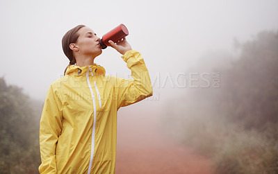 Buy stock photo Nature, fitness and woman drinking water for running on dirt road with race or marathon training. Sports, workout and young female athlete enjoying beverage for hydration on outdoor cardio exercise.