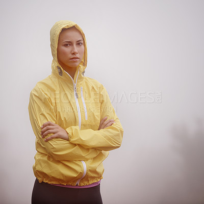 Buy stock photo A young female runner standing in a misty setting