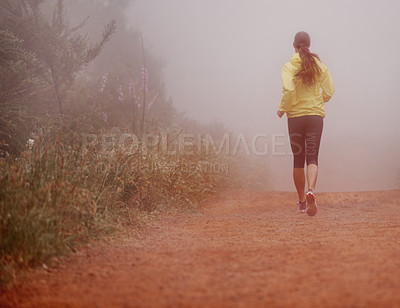 Buy stock photo Woman, rear view and running in woods with exercise for fitness, morning routine and workout with fog and legs. Athlete, person and cardio with sportswear on outdoor trail and forest for wellness