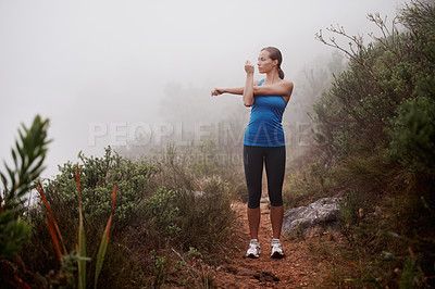 Buy stock photo Fitness, woman and stretching arms in nature, wellness or sports with fog. Park, serious runner and warm up outdoor with mist for exercise, training and thinking of workout for body health on mockup
