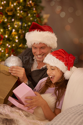 Buy stock photo Father, girl and christmas with wow, gift and happy on sofa together with box, hat and christmas tree. Dad, child and holiday celebration with present, giving or surprise on couch in home living room