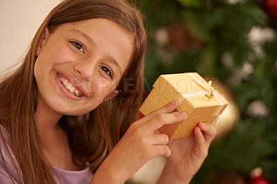 Buy stock photo Christmas, tree and portrait of child with gift box, smile and celebration with happy surprise package in home. Holiday, festive and girl with present, xmas gratitude and excited fun in apartment
