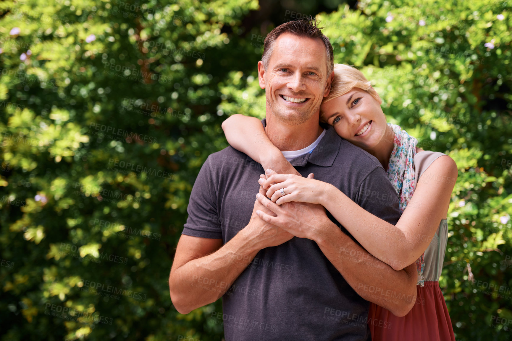 Buy stock photo Portrait, hug and happy couple in a park with love, support and bonding in nature together. Face, romance and people embrace in a forest for summer date, travel or weekend, holiday or vacation fun