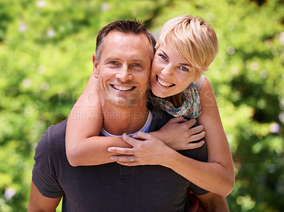 Buy stock photo Shot of a mature man giving his wife a piggyback ride