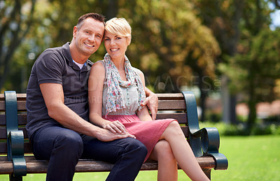 Buy stock photo Portrait, hug and couple relax in a garden with love, support and security, romance or bonding in nature. Happy, face and people embrace on a park bench for travel, holiday or weekend trip in London