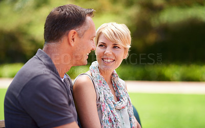 Buy stock photo Happy, love and couple in a park with conversation, chat or romantic bonding in nature together. Smile, trust and people in a forest for travel, vacation or holiday, trip or date outdoor with support