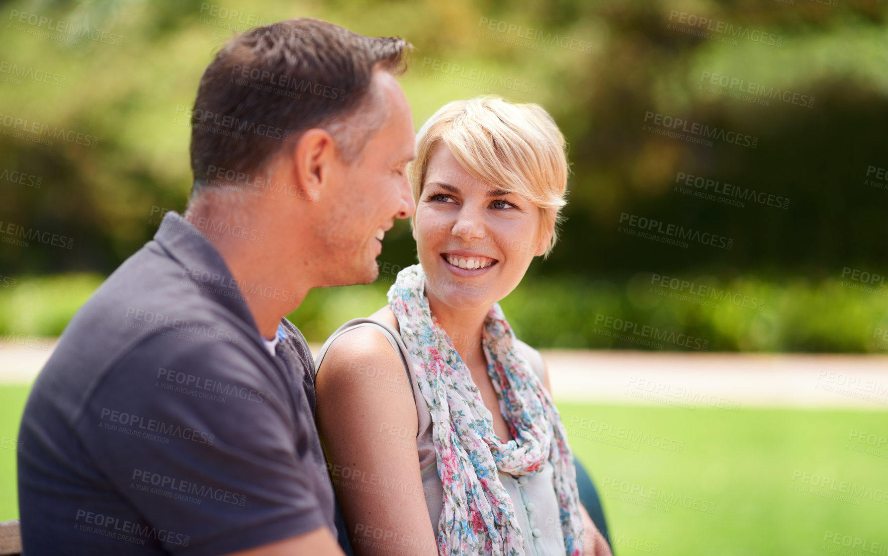 Buy stock photo Happy, love and couple in a park with conversation, chat or romantic bonding in nature together. Smile, trust and people in a forest for travel, vacation or holiday, trip or date outdoor with support